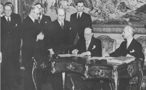 Foreign Ministers Aleksandar Cincar-Marković of Yugoslavia and László Bárdossy of Hungary signing the Treaty of Eternal Friendship between Yugoslavia and Hungary; Hungarian Prime Minister Pál Teleki (with glasses) is on the left, Budapest, 14 March 1941 (public domain via Wikipedia)