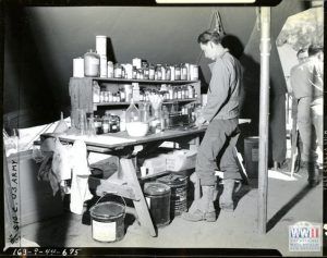Soldier pharmacist at his work bench in the pharmacy at Hunter Liggett Military Reservation, 1944 (US Army photo via National WWII Museum)