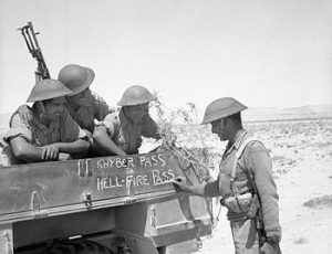 Troops of Indian 4th Division decorating their truck with “Khyber Pass to Hellfire Pass,” noting their service in South Asia and North Africa, 21 Jun 1941 (Imperial War Museum: 4700-32 E 3660)