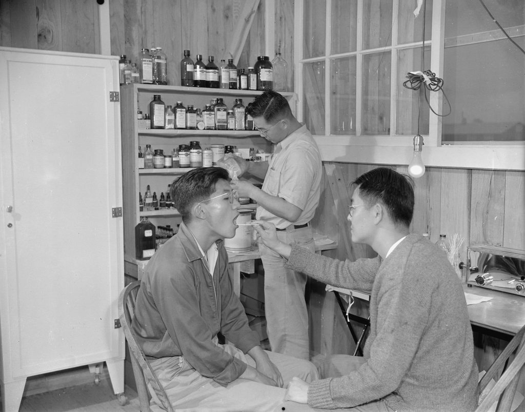 Japanese-Americans Dr. K. H. Taria and pharmacist Tom Arase at work, Jerome War Relocation Center, Arkansas, 17 Nov 1942 (US National Archives: ARC 538864)