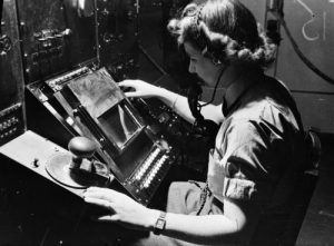 WAAF radar operator Denise Miley plotting aircraft on the CRT (cathode ray tube) of an RF7 Receiver in the Receiver Room at Bawdsey Chain Home Station (Imperial War Museum: CH 15332)