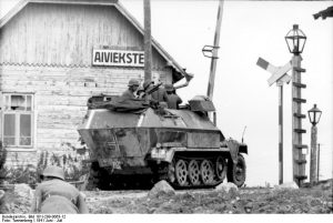 German SdKfz. 251/1 halftrack vehicle at a rail crossing, Aiviekstes, Latvia, Jun 1941 (German Federal Archive: Bild 101I-209-0063-12)