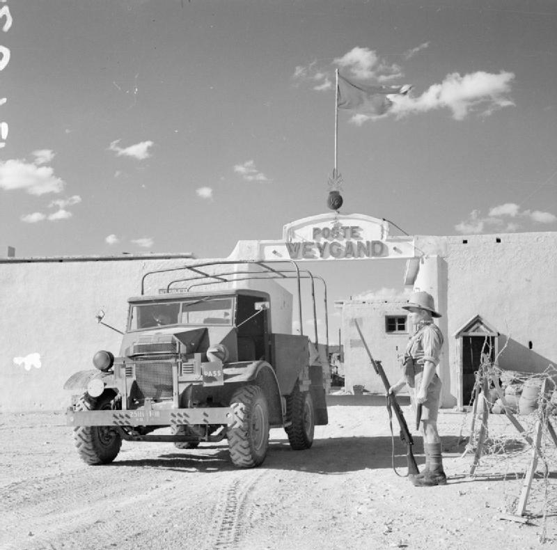 A 15-cwt truck passes a sentry as it leaves Fort Weygand at Palmyra, Syria, 12 July 1941 (Imperial War Museum: E 4079)