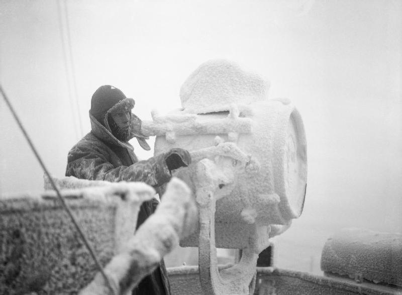 Ice forming on 20-inch signal projector on cruiser HMS Sheffield while she escorts an Arctic convoy to Russia, December 1941 (Imperial War Museum: A 6872)