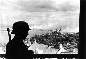 German sentinel in the citadel of Kiev with the burning Dnieper River Bridge in the background, 20 September 1941 (German Federal Archive: Bild 183-L20208)