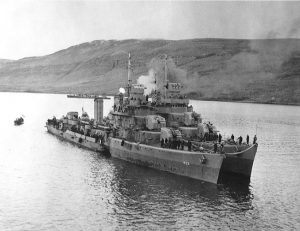 Destroyer USS Kearny at Reykjavik, Iceland, 19 October 1941, two days after being torpedoed by U-568; destroyer USS Monssen is alongside; note the torpedo hole (US Naval History and Heritage Command: 80-G-28788)