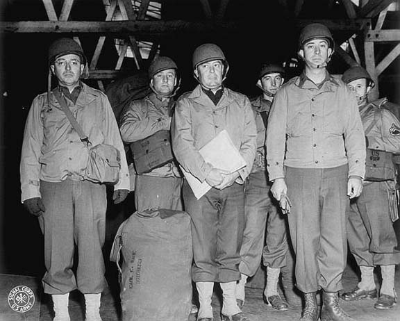 Soldiers wearing the Parsons field jacket and M1 helmet, WWII (US Army Signal Corps photo)