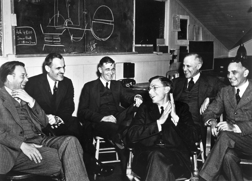Leaders of the S-1 project consider the feasibility of the 184-inch cyclotron at University of California, Berkeley, March 29, 1940: left to right: Ernest O. Lawrence, Arthur Compton, Vannevar Bush, James B. Conant, Karl Compton, Alfred Loomis (US Department of Energy photo: HD.1A.018)