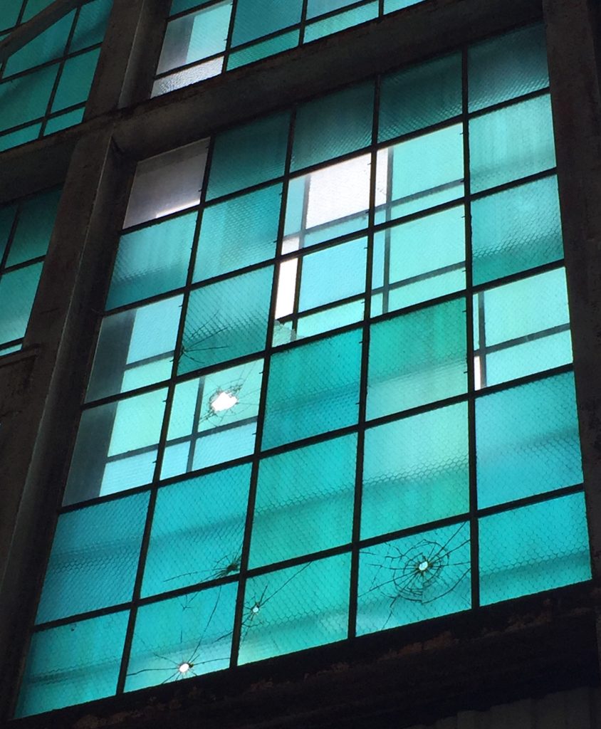 Window in Hangar 79 at the Pacific Aviation Museum, showing bullet damage from the attack on Pearl Harbor (Photo: Sarah Sundin, 7 Nov 2016)