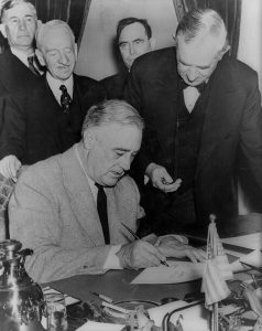 Pres. Franklin Roosevelt signing the declaration of war against Germany, 11 Dec 1941; Senator Tom Connally at right marked the time of declaration (Library of Congress: LC-USZ62-15185)
