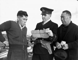 Royal Canadian Navy officer questioning Japanese-Canadian fishermen while confiscating their boat, 9 Dec 1941 (Library & Archives Canada)