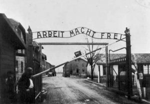 Gates at Auschwitz concentration camp, 1945 (public domain via WW2 Database)