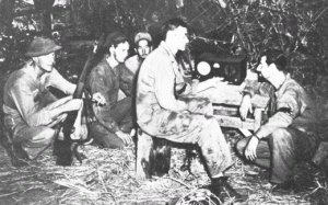 US soldiers listening to radio broadcast on Bataan Peninsula, 1942 (US Army Center for Military History)