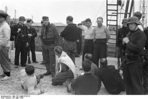 Germans guarding British prisoners of war, Saint-Nazaire, France, 28 Mar 1942 (German Federal Archive: Bild 101II-MW-3720-16)