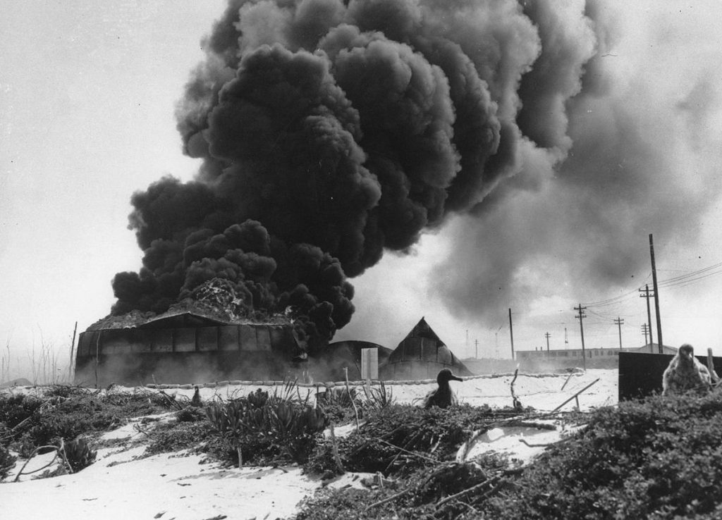Oil tanks burning on Midway Atoll after Japanese attack, 4 Jun 1942 (US National Archives)