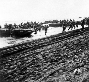 US First Division Marines storm ashore across Guadalcanal's beaches, 7 August 1942, from attack transport USS Barnett and attack cargo ship USS Fomalhaut (US National Archives: 80-CF-112-5-3)