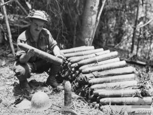 Australian soldier examines Japanese artillery shells abandoned at Ioribaiwa, New Guinea, Sept. 1942 (Australian War Memorial)
