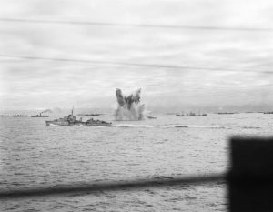 German bomb exploding near HMS Ashanti, HMS Wheatland, and HMS Eskimo, escorting Allied convoy PQ-18, Sep 1942 (Imperial War Museum)