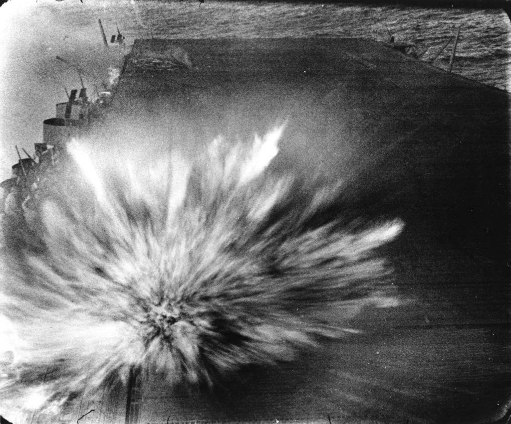 Bomb exploding on the flight deck of carrier USS Enterprise during Battle of the Eastern Solomons, 24 Aug 1942 (US National Archives)