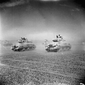 Sherman tanks of the Eighth Army speed across the desert as Axis forces retreat from El Alamein, November 1942 (Imperial War Museum: E 18971)