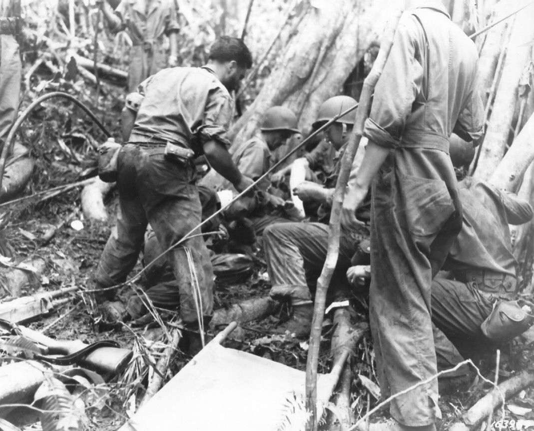 Litter bearers of the 25th Medical Battalion of US 25th Division giving first aid, Guadalcanal, 10 Jan 1943 (US Army photo)