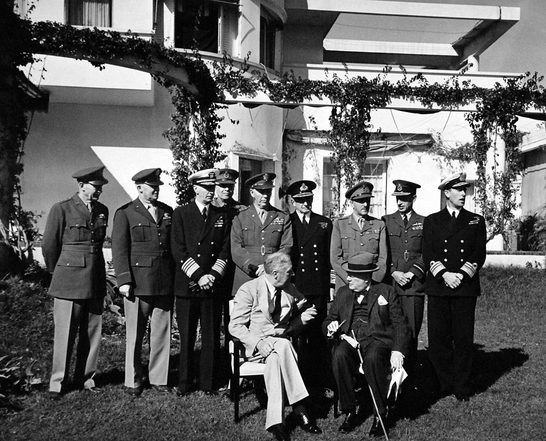 Allied leaders at the Casablanca Conference, January 1943. Seated: President Roosevelt and Prime Minister Churchill; standing, left to right: Gen. Brehon Somervell, Gen. H.H. Arnold, Adm. Ernest King, unidentified, Gen. George Marshall, Adm. Sir Dudley Pound, Gen. Sir Alan Brooke, Sir Charles Portal, and Vice Adm. Louis Mountbatten (US National Archives: 80-G-38559)