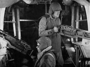 Waist gunners on a B-24 Liberator wearing protective flak vests and helmets (US National Archives)