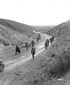 US troops marching through Kasserine Pass, Tunisia, 26 Feb 1943 (US Army Signal Corps photo: SC 167571)