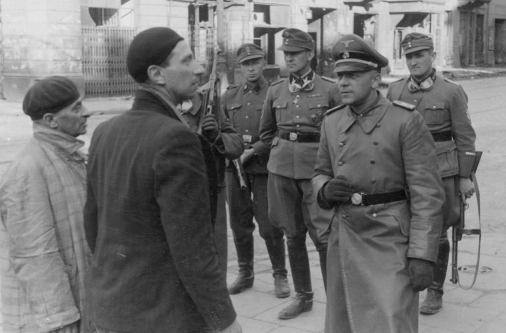German officer questioning Jews in Warsaw, Poland, 14-15 May 1943 (US National Archives)