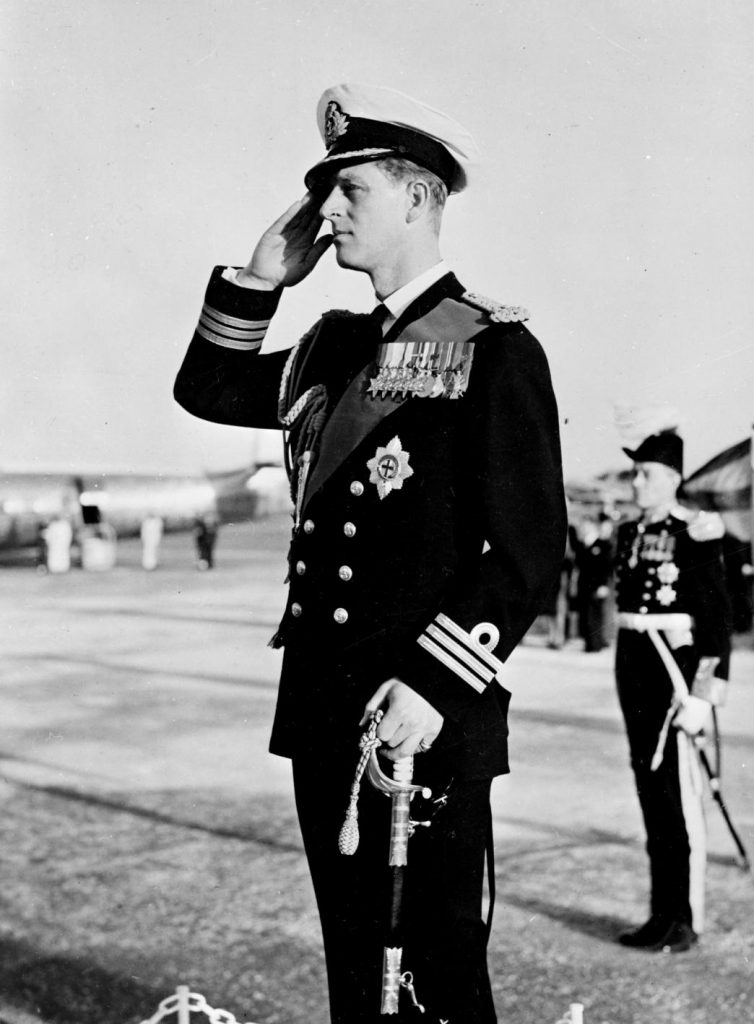 Prince Philip, Duke of Edinburgh in the uniform of a Commander, Royal Navy, takes a Royal Salute during his visit to Malta in 1952 (Imperial War Museum: A 32405)