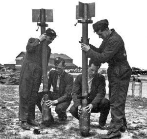 Attaching warheads to RP-3 3-inch Rocket Projectiles (Men attaching 60-lb warheads to 3-inch RP-3 Rocket Projectile bodies, WWII (Imperial War Museum)