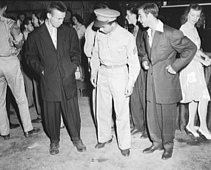 Soldier inspecting zoot suits at the Uline Arena, Washington DC, 1942 (Library of Congress)