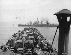Light cruiser USS Boise firing on armored forces near Gela, Sicily as USS LST-325 approaches landing beaches, 11 Jul 1943 (US National Archives: SC 175981)