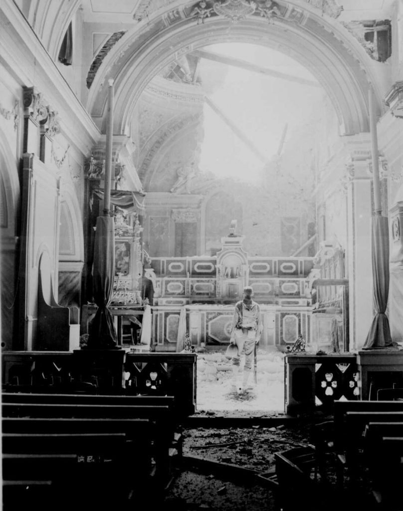 Pvt. Paul Oglesby of US 30th Infantry Regiment in a damaged Catholic Church at Acerno, Italy, 23 September 1943 (US National Archives: 111-SC-188691)