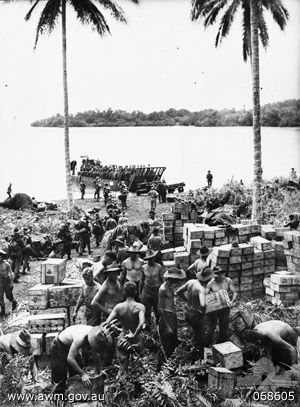 Australian transport company unloads supplies at Finschhafen, Oct. 1943 (Australian War Memorial: 068605)