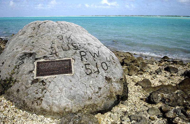 Memorial for the 98 US civilian contract POWs who were executed by the Japanese on 7 Oct 1943; an unidentified prisoner escaped and chiseled "98 US PW 5-10-43" on this rock before he was executed himself (US Air Force photo: 080112-F-2034C-203)