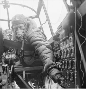 Flying Officer J.B. Burnside, Lancaster flight engineer of No.619 Squadron RAF checks settings on the control panel (Imperial War Museum: CH 12289)