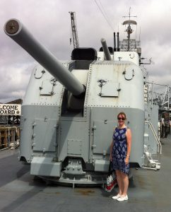 Sarah Sundin by the 5-inch gun mount on destroyer USS Cassin Young, Charlestown Navy Yard, Boston, July 2014 (Photo: Sarah Sundin)