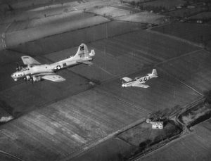 B-17 Flying Fortress "Maiden America" of the 385th Bomb Group is escorted on a mission by two P-51 Mustangs, including P-51D "Marymae" of the 357th Fighter Group (Imperial War Museum, Roger Freeman Collection: FRE 1404)