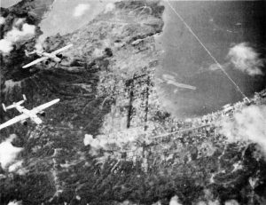 US COMAIRSOLS B-25 Mitchell bombers attacking Rabaul, New Britain, late 1943; note Lakunai airfield in top center of photo (public domain via WW2 Database)
