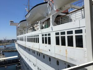 Boarding the Queen Mary - the sun deck (under the lifeboats), the promenade deck (rectangular windows), and main deck (round portholes).