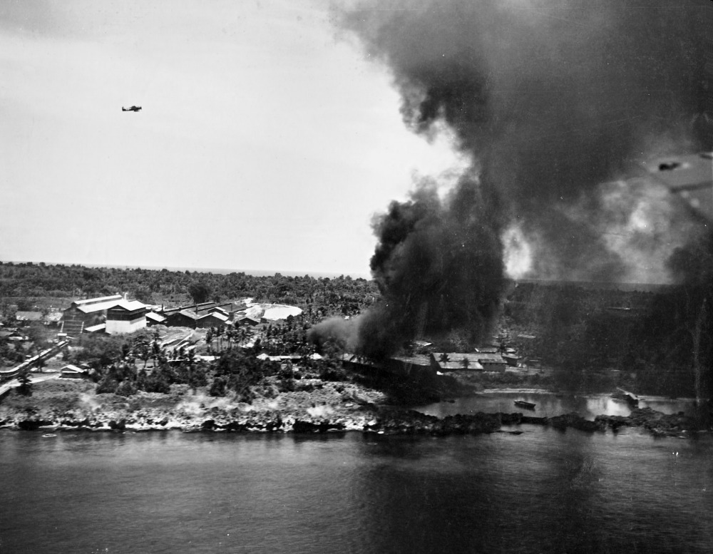 Peleliu Island under attack by aircraft of US Navy Task Force 58 (note F6F fighter in flight), 30 March 1944 (US National Museum of Naval Aviation)