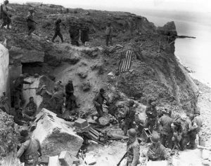 US 2nd Ranger Battalion at Pointe du Hoc after relief on D+2 (June 8, 1944), when American flag had been spread out to stop fire of friendly tanks coming from inland. Some German prisoners are being moved in after capture (US Army Signal Corps photo)