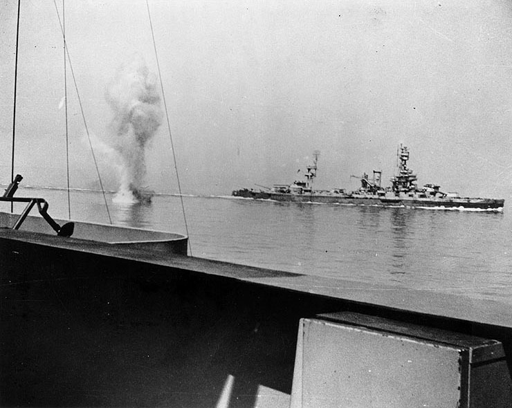 German coast artillery shell falling between battleships USS Texas (background) and USS Arkansas (foreground) off Cherbourg, France, 25 June 1944 (US National Archives)
