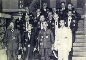 Japanese Prime Minister Kuniaki Koiso (3rd from left, front row) and his cabinet, 22 July 1944 (public domain via Wikipedia)