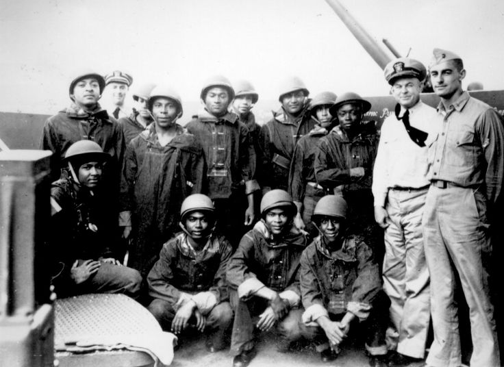 African-American mess attendants/gunners and white officers aboard cruiser USS Indianapolis, 10 July 1942 (US National Archives)