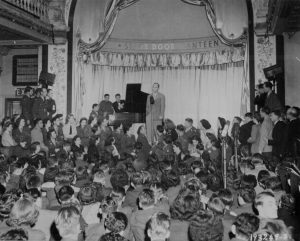 Bing Crosby singing at the opening of the Stage Door Canteen in London, 31 August 1944 (US National Archives)