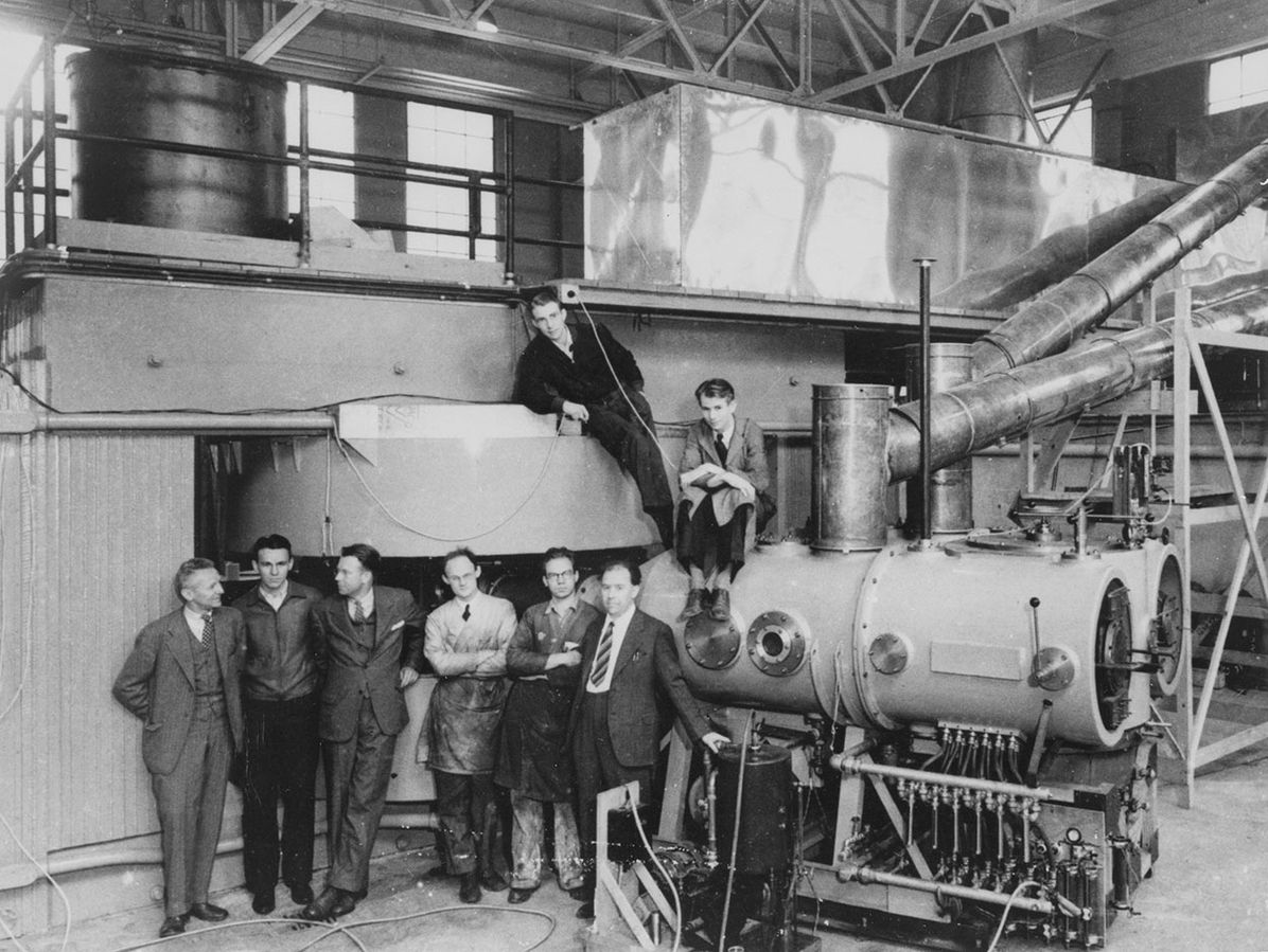 Cyclotron at the Lawrence Radiation Laboratory, Berkeley, CA in 1939; the key figures in its development and use are shown, left to right: Dr D Cooksey, Dr D Corson, Dr Ernest Lawrence, the inventor of the cyclotron; Dr R Thornton, Dr J Backus, WS Sainsbury, Dr LW Alvarez, and Dr Edwin Mattison McMillan (Science Museum London)
