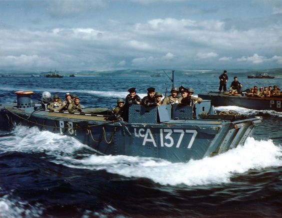 British Navy Landing Craft LCA-1377 carries US 5th Rangers to transport HMS Baudouin, Weymouth, England, June 1, 1944. Rangers include Lt. Stan Askin, Capt. John Raaen, Maj. Richard Sullivan, and chaplain Father Lacy, carrying medical supplies. British sailors in the conning tower (US National Archives)