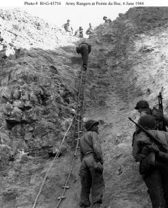 Rangers climbing the cliff of Pointe du Hoc on D+2 (June 8, 1944), bringing up supplies. A ladder, a toggle rope, and two plain ropes are in view ((US Navy photo #80-G-45716)